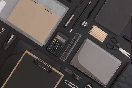 Pattern composition of office and school stationery on black leather background. Back to school