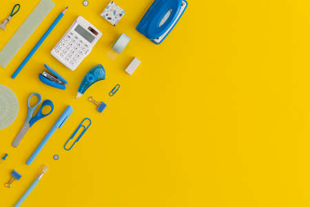 School stationery on a yellow background. Top view with copy space. Flat lay. Back to school concept.の写真素材