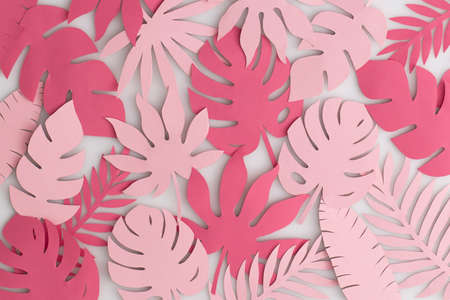 Tropical pink paper leaves on white background.Summer concept. Top view, flat lay.