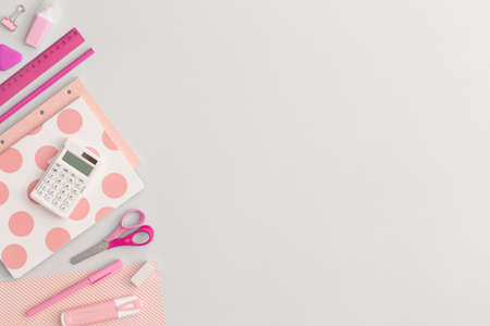 Pink school stationery on a gray background. Top view. Flat lay. Back to school concept.