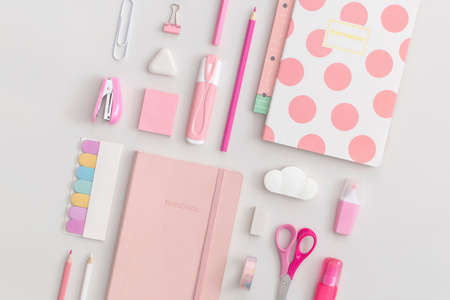Pink school stationery on a gray background. Top view. Flat lay. Back to school concept.の写真素材