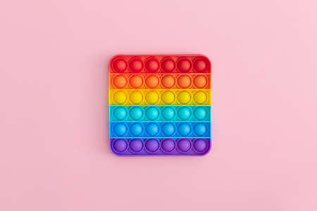 Colorful anti-stress  sensory toys for children on pink background.