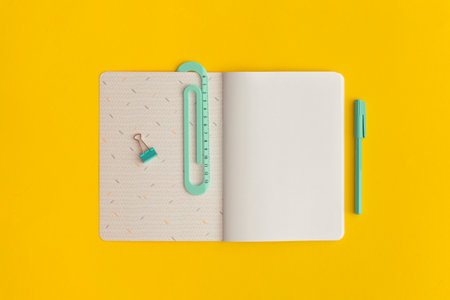 School stationery and notebook on a yellow background. Top view with copy space. Flat lay. Back to...