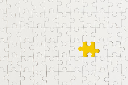 White details of puzzle on yellow background. Business strategy, teamwork.の写真素材