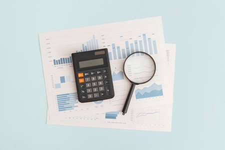 Business graphs, charts, magnifying glass and calculator on table. Financial development, Banking Account, Statisticsの写真素材