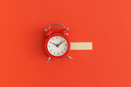 Red alarm clock on red background