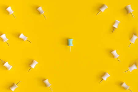 Push pins on yellow backgound. Leadership concept.の写真素材