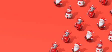 Composition of Christmas toys on red background with hard shadows and space for text.