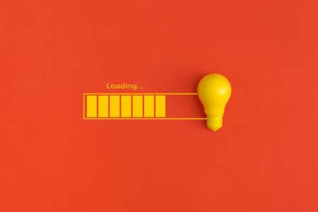 Light bulb and loading on red background. Inspiration and creative idea concept.の写真素材