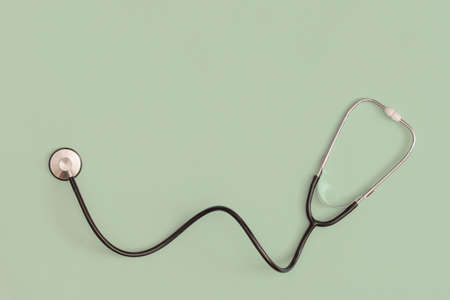 Stethoscope on green background. Top view. Flat lay. Medicine concept.の写真素材