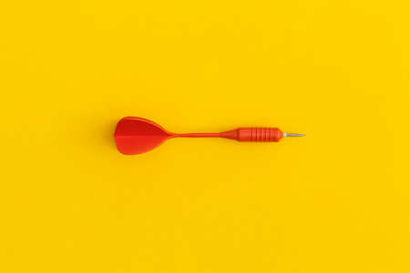 Dart on a yellow background. Top view. Flat lay.の写真素材