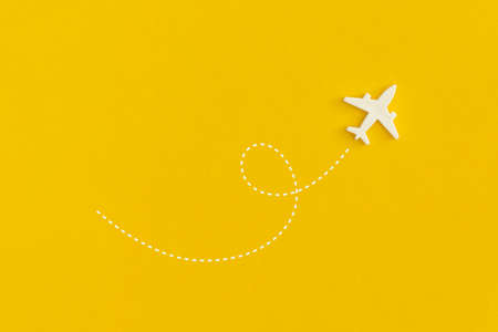 Toy airplane on a yellow background. Top view. Flat lay.