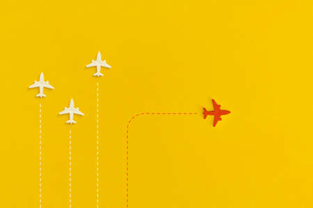 Toy airplanes on a yellow background. Leadership and new idea concept.の写真素材