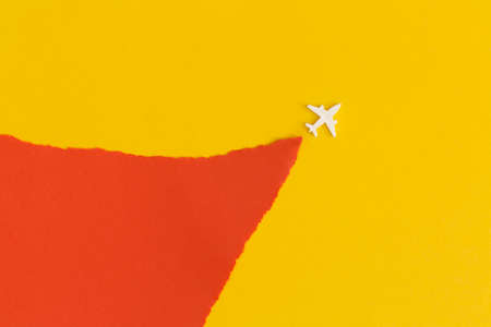 Toy airplane on a yellow background. Top view. Flat lay.の写真素材