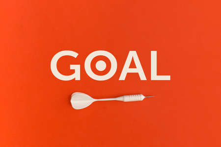 Dart and word Goal on a red background. Top view. Flat lay.の写真素材
