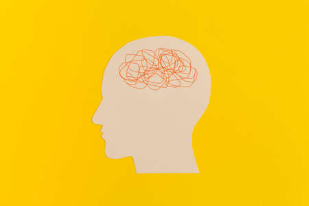 Human head with confused thoughts on yellow backgroundの写真素材