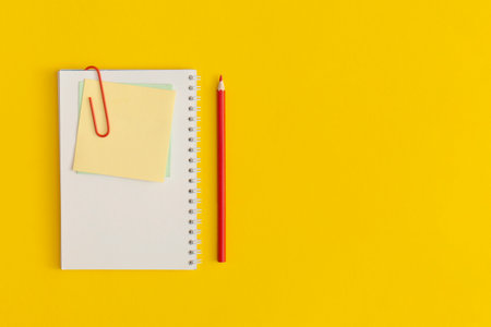 Notebook on yellow background. Top view. Flat lay. Back to school concept.の写真素材
