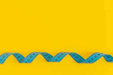 Measuring tape on yellow backgroundの写真素材