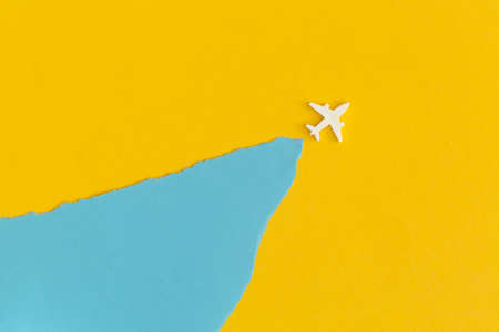 Toy airplane on a yellow background. Top view. Flat lay.
