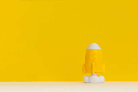 Rocket on yellow background, startup business idea