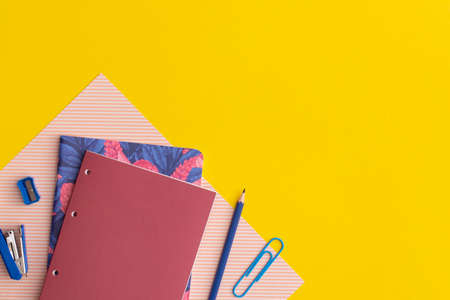 School stationery on yellow background. Top view with copy space. flat lay. Back to school concept.