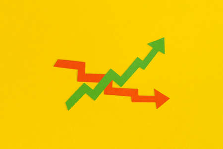 Business growth and decline concept. Financial report with graphs and arrows.の写真素材