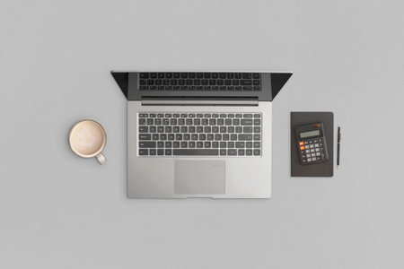 Laptop, calculator, notebook, pen on gray background. Financial development, Banking Account,...