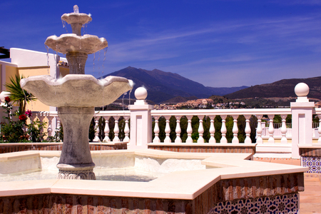 Fountain. Beautiful Spanish architecture. Mountain and sky.の写真素材