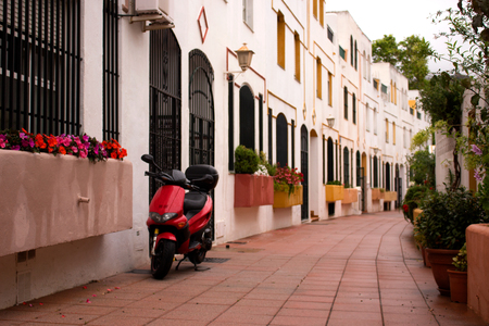 Scooter in the street. White house. Spain, Andalusia, Costa del Sol.の写真素材