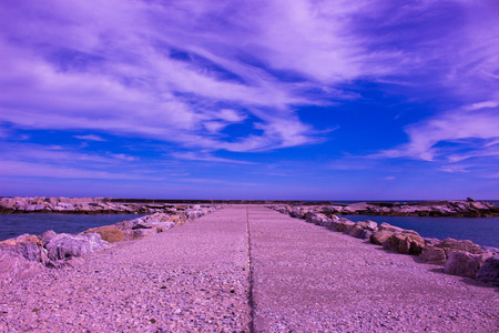 Breakwater. Beautiful sunset view. Mediterranean sea. Puerto Banus, Marbella city, Costa del Sol, Andalusia, Spain.の写真素材