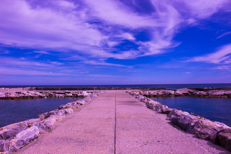 Breakwater. Beautiful sunset view. Mediterranean sea. Puerto Banus, Marbella city, Costa del Sol, Andalusia, Spain.の写真素材