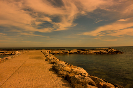 Breakwater. Beautiful sunset view. Mediterranean sea. Puerto Banus, Marbella city, Costa del Sol, Andalusia, Spain.の写真素材