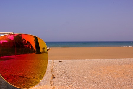 Sunglasses. Beautiful summer beach and sunglasses. Costa del Sol, Andalusia, Spain.の写真素材