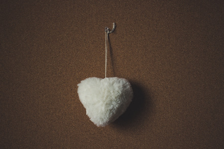 Heart. White Fur Heart on a brown background.の写真素材