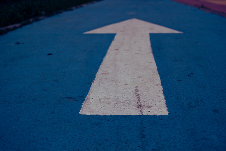 Arrow White arrow on the blue floor. Road sign.の写真素材