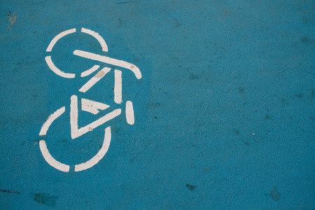 Bicycle. White bicycle sign on a blue road. Road sign.の写真素材