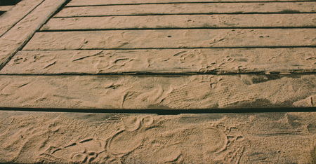 Wooden background. Wooden panels with beach sand and traces.の写真素材