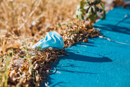 Medical face mask on the floor in the street.の写真素材