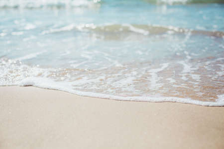 Soft blue ocean wave on sandy beach. Background.