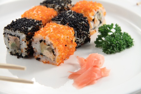 Sushi rolls and ginger on a white plateの写真素材