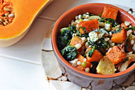 roasted pumpkin with pearl barley, spinach and creamy blue cheeseの写真素材