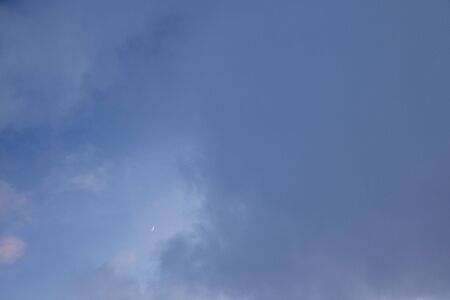 the dark evening sky with moon and thick heavy clouds. Background with copy space for text