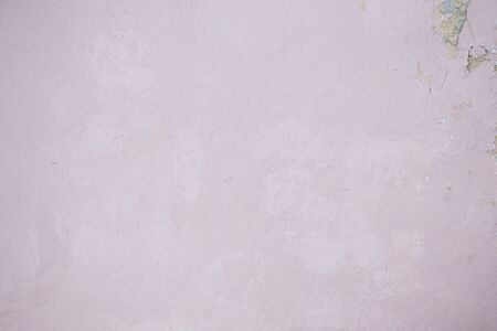 Pink concrete wall with chipped and scratches. Aged texture and backgroundの写真素材