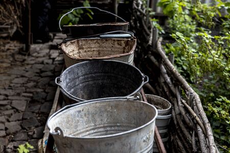 The empty old buckets are in the garden. Rural life