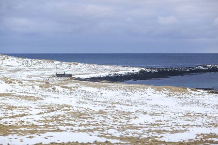 the coastline of the Atlantic ocean in Iceland, with beautiful rocks and mountains