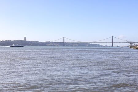 Beautiful iron cross across the river in Portugal. 25th of April bridge in Lisbon