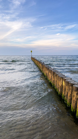 Wooden breakwater in the Baltic sea at sunset, Poland.の写真素材