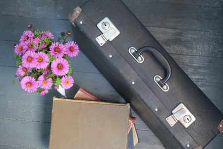 Suitcase, flowers and books