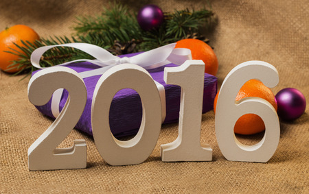 Tag 2016, purple gift with postcard, orange tangerines, fir-cones, Christmas decorations and...