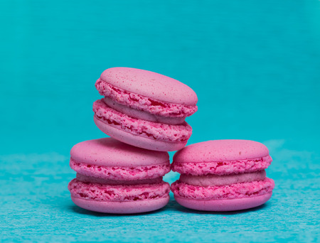Three pink macaroons on blue backgroundの写真素材